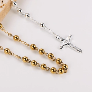 Minimalist beaded necklace with cross pendant in polished gold and silver metal finishes