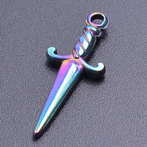 Macro shot of a rainbow-plated stainless steel mini sword pendant on leather surface
