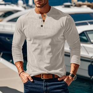 Close-up of beige men's ribbed knit henley shirt with button collar detail at marina