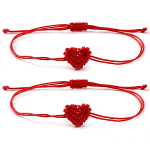 Two pieces of handmade woven red heart bracelets with adjustable strings for couples