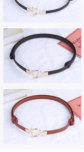 Three-color set of slim leather belts with gold round buckles on white fabric background
