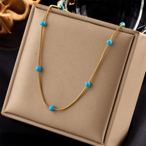 Gold-plated stainless steel chain necklace with small turquoise beads on display box