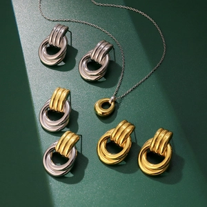 Three pairs of interlocking hoop earrings and matching necklace set in gold and silver