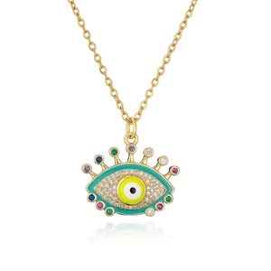 Macro detail of gold plated evil eye pendant necklace with colorful zircon gemstones