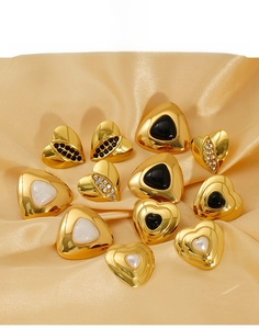 Close-up of 18K gold plated titanium steel heart earrings with black onyx and pearls