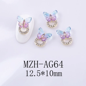 Detail of blue purple gradient butterfly nail charms with gold ring and rhinestones