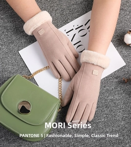 Detail showing pink suede gloves with plush faux fur cuffs and fashion logo patch