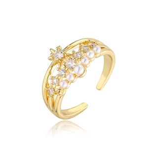Detailed shot of 18K gold plated ring with zircons and pearls on white mirror background