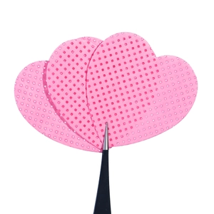 Pink heart-shaped eyelash glue cleaning pads with textured surface and professional tweezers