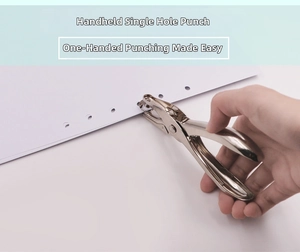 Macro view of handheld single hole metal puncher performing precise paper binding