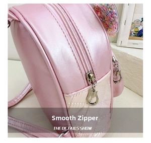 Detail of pink pearlescent PU backpack with smooth heart-shaped zipper and sequins