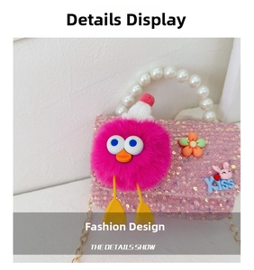 Detail view of pink sequin girl's bag with pearl handle and plush monster charm