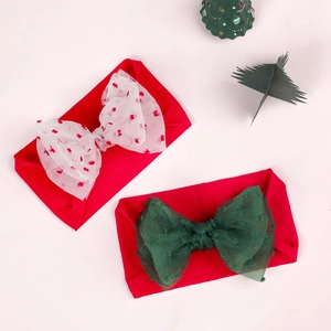 Detail of baby Christmas headbands with red festive nylon and tulle bow designs