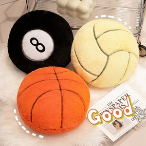 Plush sports ball pillows in basketball and volleyball designs on white shag carpet