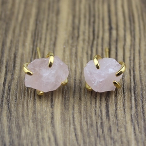 Detailed view of pink natural crystal stone earrings in a four-claw gold-plated setting