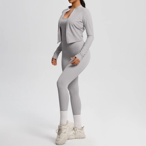 Detailed side view of three-piece fitness set including grey zip jacket, tank, and leggings