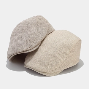 Classic knit beret hats in beige and light grey showing retro vintage style texture