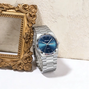 Close-up of elegant men's watch featuring a blue gradient dial with day and date display