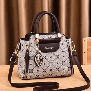 Women's luxury handbag with geometric patterns, dual top handles and cross-body strap