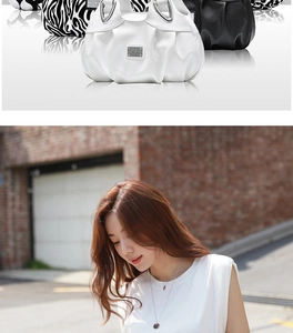 Detail view of stylish pleated tote bags in black, white, and zebra print with metal handles