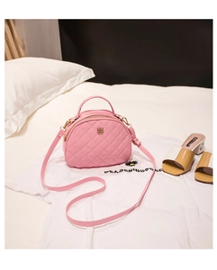 Detail of pink quilted handbag with floral gold clasp and adjustable shoulder strap