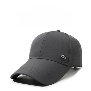 Detail of dark gray baseball cap with laser-cut breathability and metal peak logo