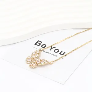 Close-up of golden butterfly pendant with white marquise and round cubic zirconia stones