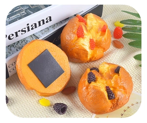 Detail of realistic artificial muffin magnets with faux strawberry and mulberry topping