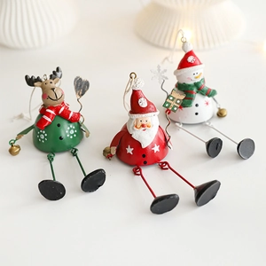 Three metal Christmas ornaments featuring Santa, reindeer, and snowman in festive red and green