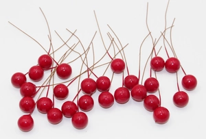 Close-up of artificial red berries with brown stems for DIY floral arrangements