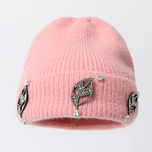 Elegant pink knit beanie for women with shimmering rhinestone leaf accents and soft fur texture