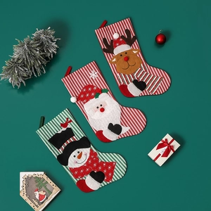 Three Christmas stockings with Santa, reindeer, and snowman designs for holiday tree decor