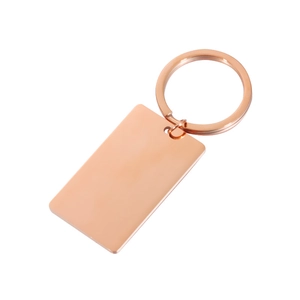 Macro shot of rose gold rectangular metal pendant keychain with a polished blank surface