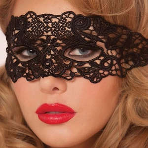 Close-up view of elegant black lace eye mask with intricate floral embroidery detail
