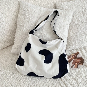 Detail of corduroy cow print tote bag showing large capacity and soft fabric texture