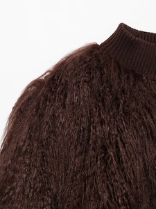 Close-up of deep brown faux fur texture and ribbed collar stitching on the autumn jacket