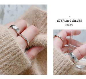 Close-up of model wearing two minimalist S925 sterling silver rings in bright silver finish