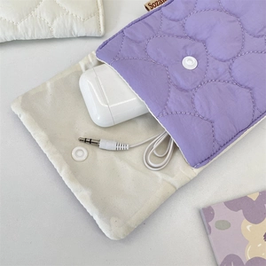 Detail view of quilted lilac pouch with flower pattern and snap closure for small items