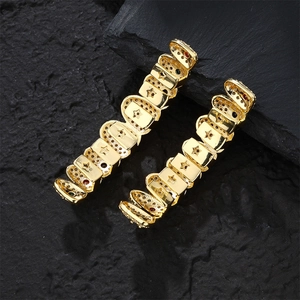 Hip hop gold grillz set with star patterns and colorful zircon stones on black rock base