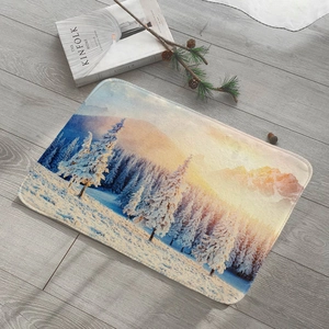 Absorbent flannel rug featuring a winter snow forest scene on a wooden floor