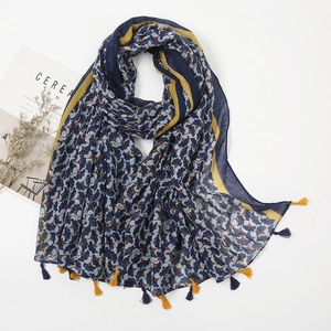 Detail of navy cotton linen scarf with shell patterns and yellow blue fringe tassels