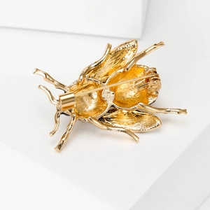 Detailed back view of golden bee brooch featuring sturdy metal pin and secure clasp closure