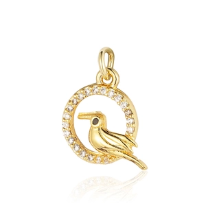 Detailed view of hummingbird pendant in gold-plated frame with sparkling zircon stones