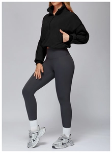 Detail of a black fleece quarter-zip pullover with elastic cuffs and a stand-up collar