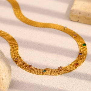 18K gold plated mesh chain necklace with vibrant multi-colored gemstones on a stone surface