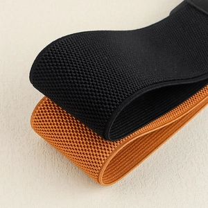 Macro shot of honeycomb textured black and brown elastic woven waist belts for women