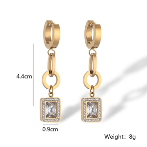 Detail view of gold geometric heart drop earrings with size markers 4.4cm by 0.9cm