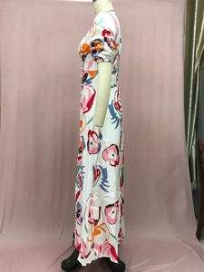 Detail of white floral maxi dress featuring short sleeves and a single-breasted button design