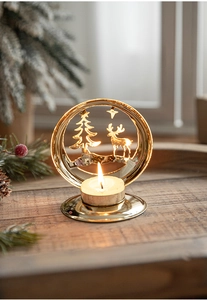 Macro view of golden iron candle holder featuring Christmas tree and reindeer cutouts