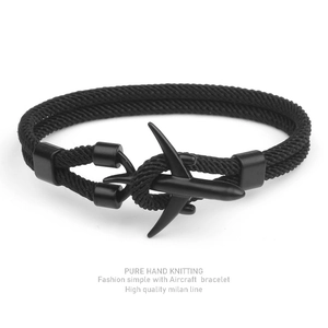 Detail of hand-knitted black milan line bracelet featuring a matte aircraft metal buckle